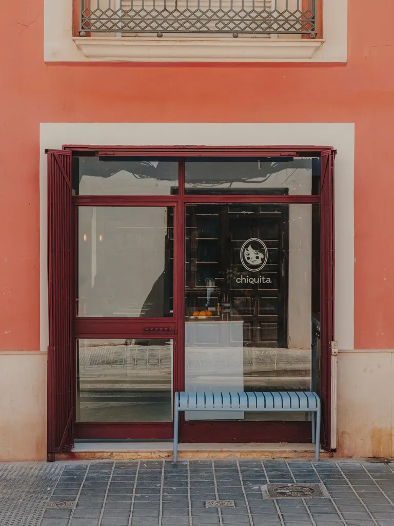 the burgundy storefront introduces Chiquita to Valencia’s El Botànic neighbourhood | all images ©Oleh Kardash Horlay