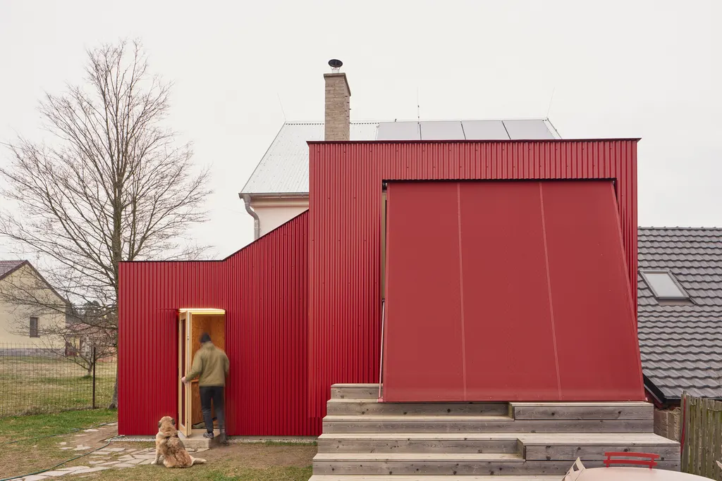 Facha Architekti added a red extension to a former-pigsty home