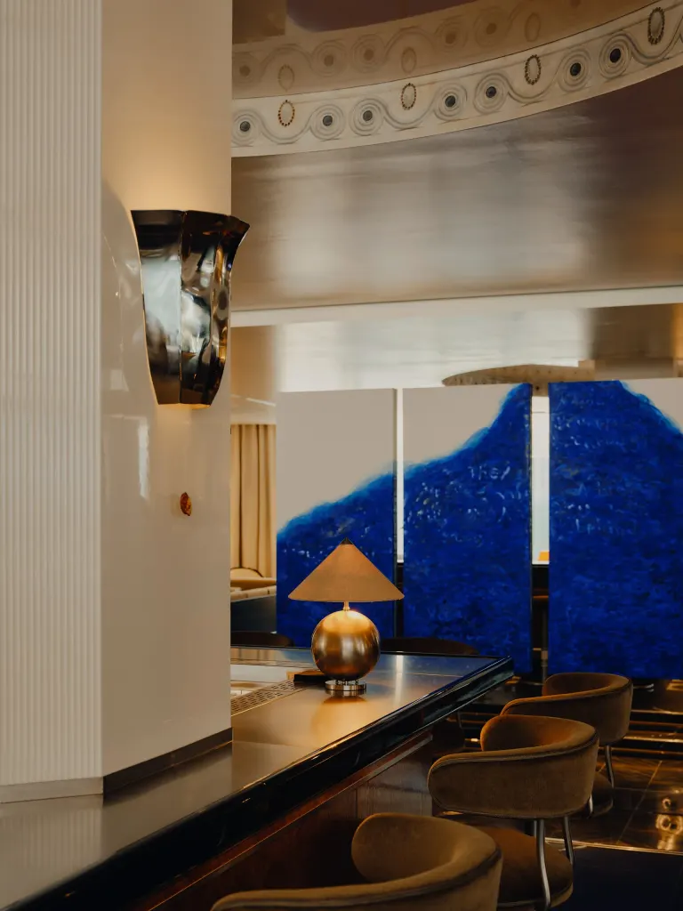 Hand-painted elements throughout the hotel, including around this bar in the center of the lobby area, add another layer of detail to the design.
