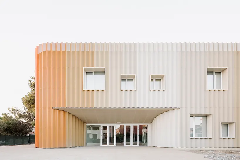 micro-perforated corrugated aluminum panels wrap the entire outer envelope
