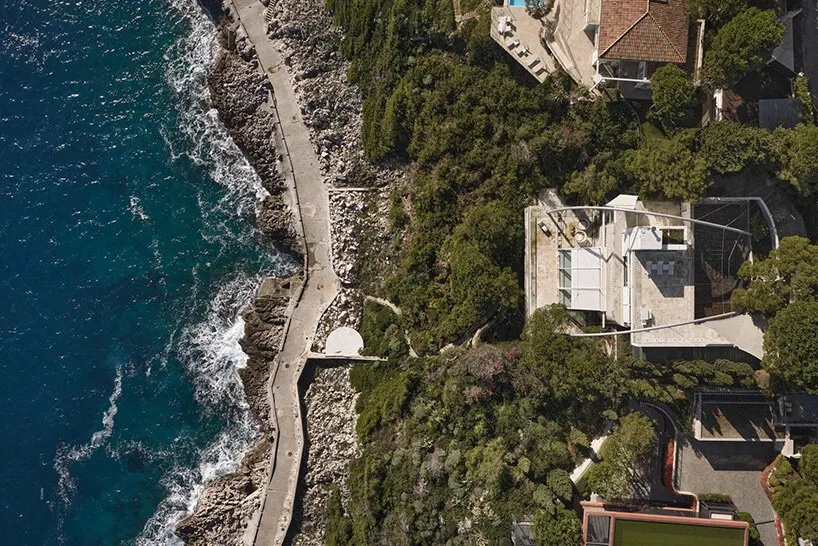 aerial view of La Voile set between the rocky coastline and the landscaped hillside