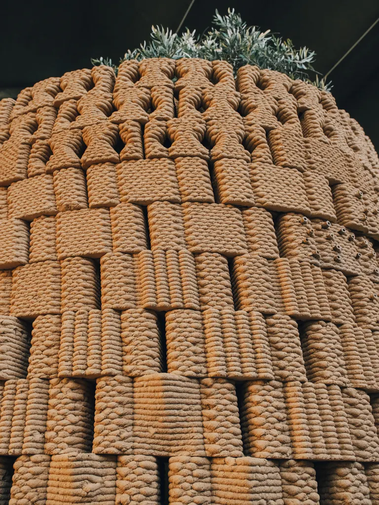 robotically 3d printed earth bricks wrap a multispecies habitat around an olive tree 2