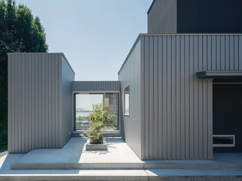 Minimalist House sits on a hill above a lakeside town in Shiga, Japan