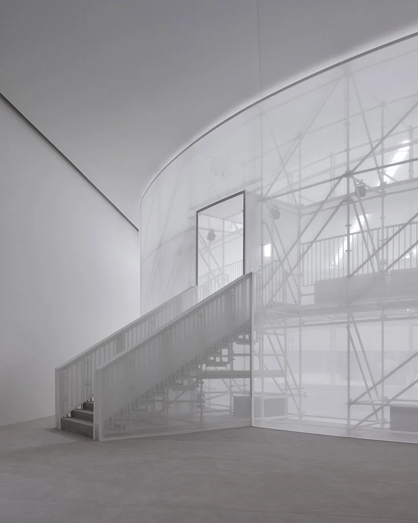 the two-story show space rises inside a temporary structure at château de vincennes