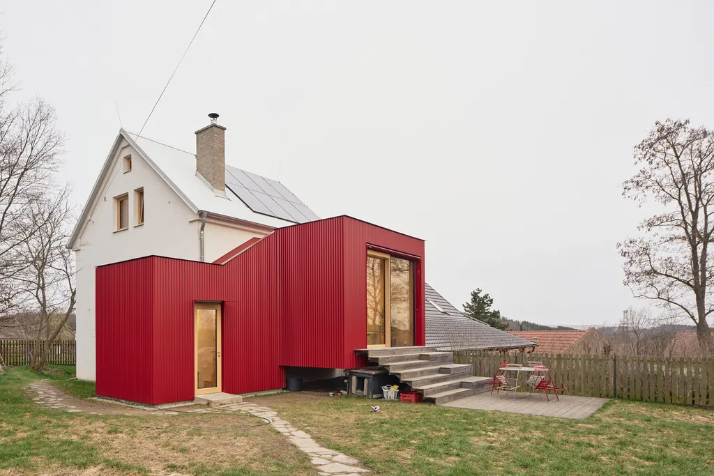 The bold extension improves connections to the garden with seating steps and a terrace