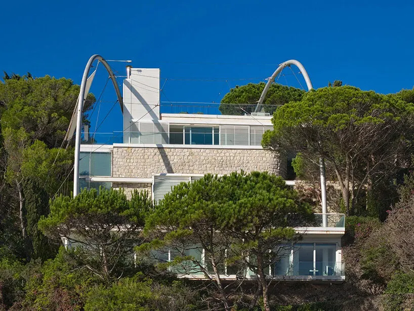 curved steel arches, stone walls, and glazed facades define the building