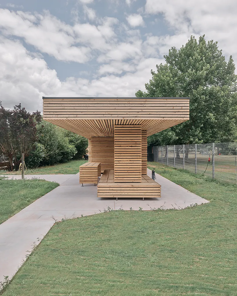 seating areas, entrances, and niches are conceived as precise cuts into the compact timber figure