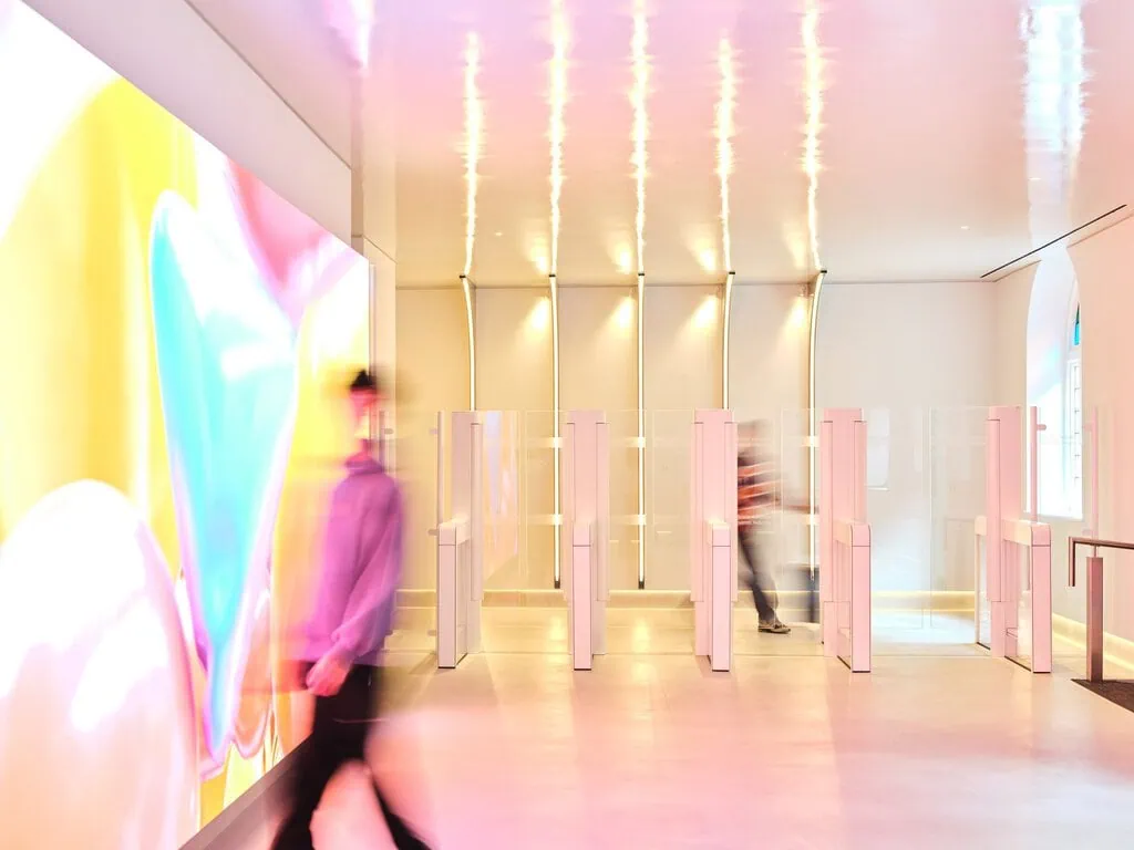 Visitors enter through a glossy lobby with e-gates