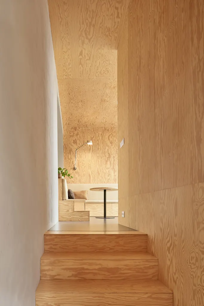 Pine cladding covers stairs, walls, ceiling and built-in furniture in the interior