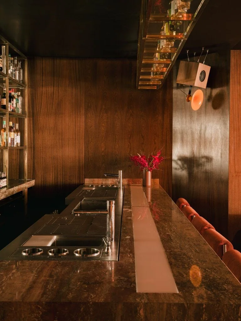 Orange velvet and chrome stools work wonders with the textured wood of the walls and a red travertine bar counter, each feeding into the retro-fueled vibe of Bar Leone.