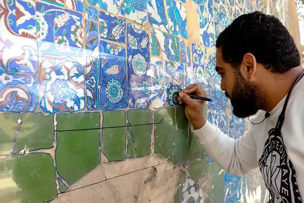 An expert helps conserve mosaics at Takiyyat Ibrahim al-Gulshani