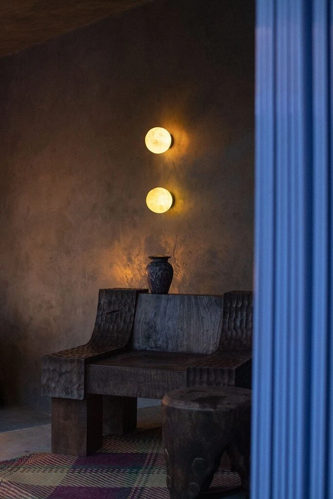 Lounge chair and side table in reclaimed timber, custom design by YSG, handcrafted by Furnistool Bali. Moon sconces in fiberglass by Anomolous, custom design by YSG. Photography by Tommaso Riva.