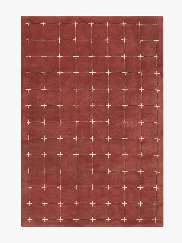 A wool rug with geometric hand-tufted shapes.