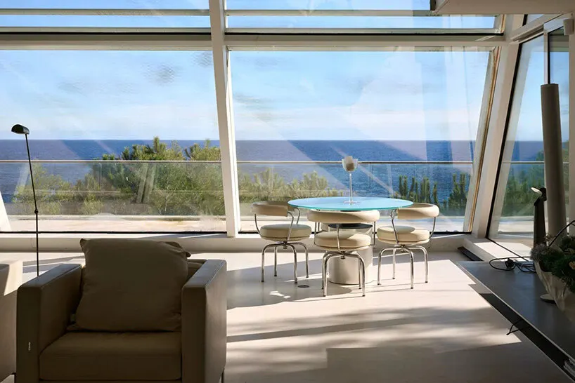 floor-to-ceiling glazing frames sea views from the living area