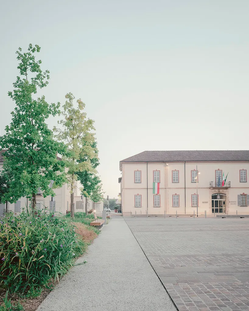 three planted edges and the existing town hall enclose the public space