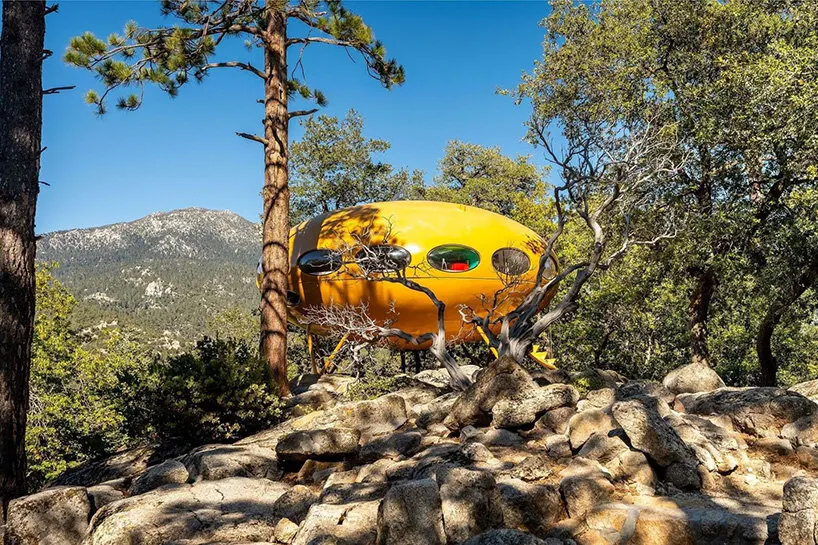 the Futuro house stands among the pine trees of the San Jacinto Mountains