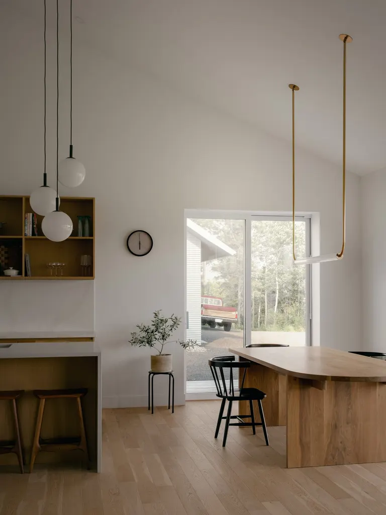 The gabled roof shapes the interior volumes