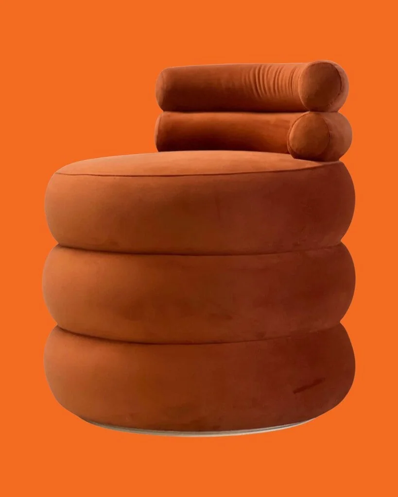 Compact Sculptural Velvet Orange Round Seat by Spinzi Milano against orange background.