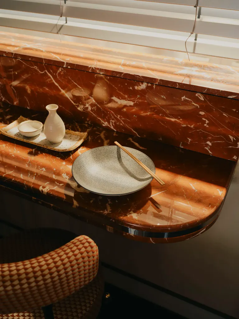 Smooth curves and a warm color palette make for an inviting dining space. Image credit: Dean Hearne / The Dean Munich