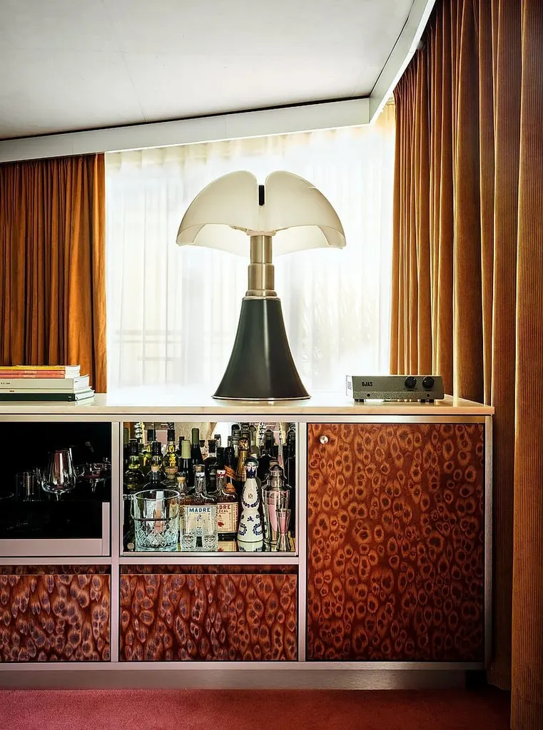 floor-to-ceiling curtains meet carpeted floors and patterned wardrobes inside the rooms