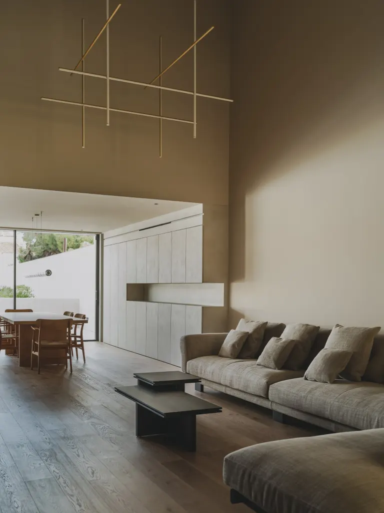 The double height living room at first floor level, adjoining the kitchen and terrace