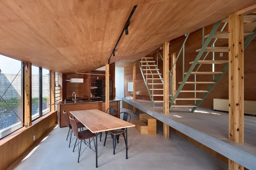 view from the living room toward the dining area and kitchen, with the washbasin beyond