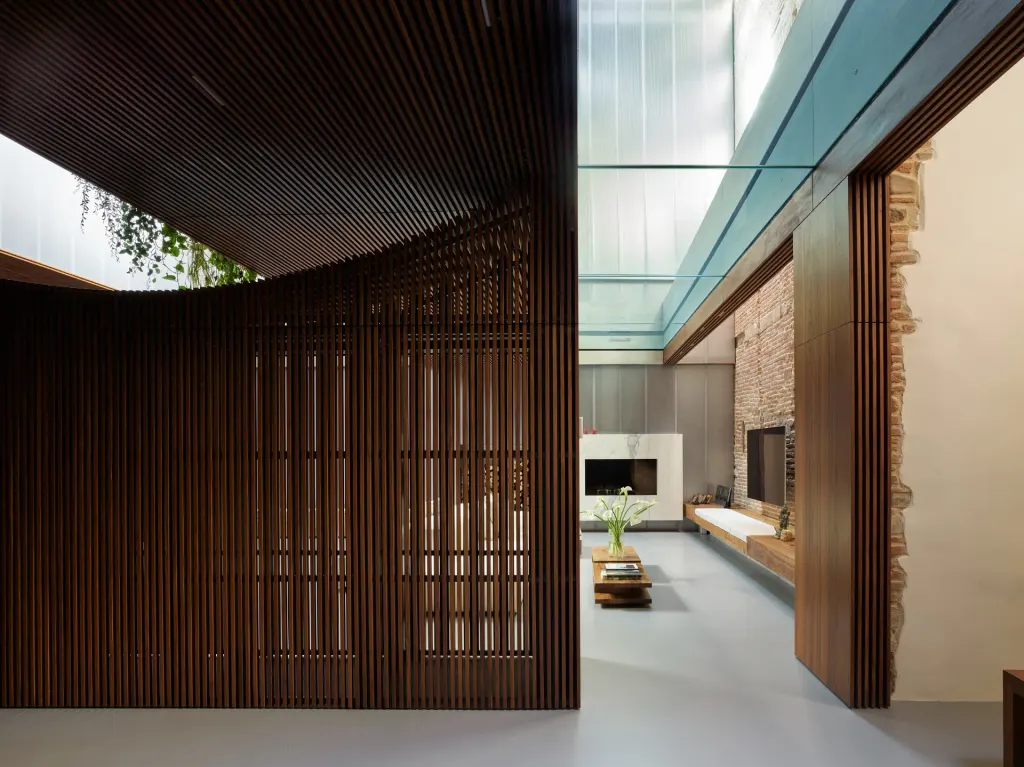 The living space is set beneath the glass-bottomed pool